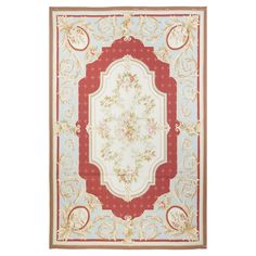 a red and white rug with an ornate design on the center, in front of a white background