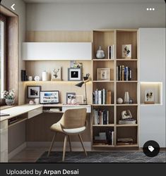 a home office with bookshelves, desk and chair in front of a window