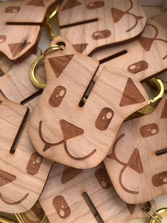 wooden keychains with cats faces on them