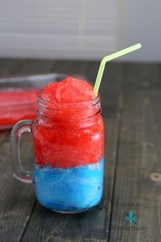 a red, white and blue drink in a mason jar with a straw sticking out of it