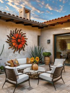 an outdoor living area with patio furniture and potted plants