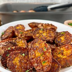 a white plate topped with fried food on top of a table