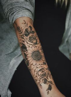 a woman's arm with flowers on it