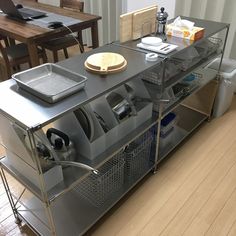 an industrial kitchen with stainless steel appliances and wood flooring on the wooden floored area