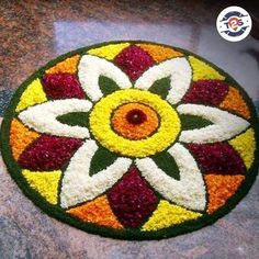 a colorful flower design is on the floor in front of a counter top with an orange, yellow and red circle