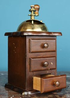 an old wooden drawer with a brass dome on top