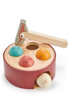 a wooden toy with different colored rocks in it