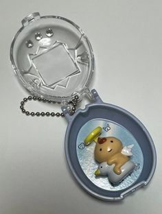 a keychain with an image of a dog and angel on it's side