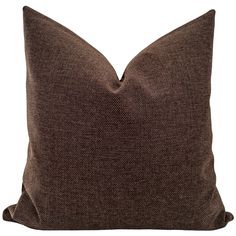 a brown pillow on a white background