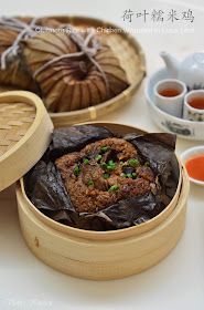 there are some food in the wooden trays on the table with tea and sauces