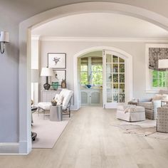 a living room filled with furniture and lots of white stuff on top of hard wood flooring