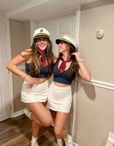 two women dressed in sailor outfits posing for the camera