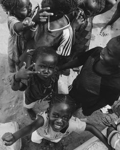 a group of children standing around each other