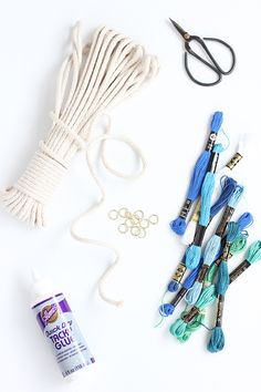 the supplies needed to make this craft include yarn, scissors, and other items that are on display