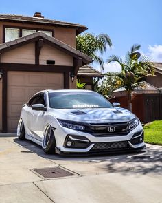 a white car parked in front of a house