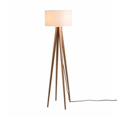 a wooden floor lamp with a white shade on the top and a black cord attached to it