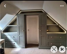 an attic bedroom with built in closets