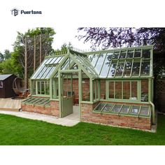 a green house sitting on top of a lush green field