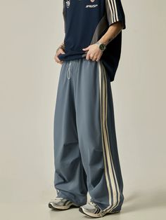 Take your workouts to the next level with our Wide-Leg Triple Stripe Athletic Pants. The wide-leg design provides maximum comfort and mobility, while the triple stripe detailing adds a touch of style. Made with high-quality materials, these pants are durable and perfect for any athletic activity. model: 174cm 61kg M material: 90% polyamide fiber (nylon). 10% polyurethane elastic fiber (spandex) Track Pants Outfits, Casual Sport Outfits, Lazy Pants, Baggy Track Pants, Track Pants Outfit, Sporty Streetwear, Sporty Pants, High Heel Sneakers, Nylon Pants