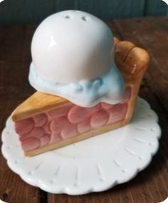 a piece of cake on a plate with a white plastic hat sitting on top of it