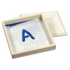 two wooden trays with blue letters on them