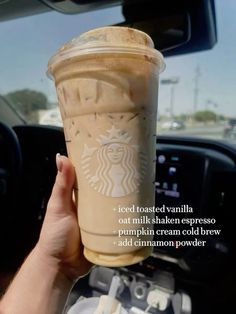 someone holding up a cup of coffee in their hand with the caption, iced roasted vanilla out milkshake espresso pumpkin cream cold brew add cinnamon powder