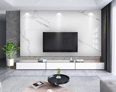 a modern living room with marble walls and flooring, white furniture and black accents