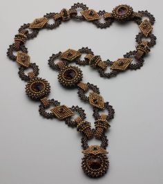 a beaded necklace is shown on a white surface