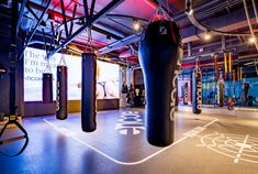 an indoor boxing gym with punching bags