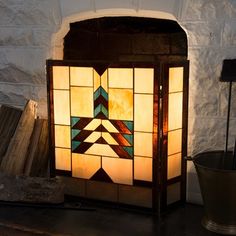 a stained glass lamp sitting on top of a table next to a potted plant