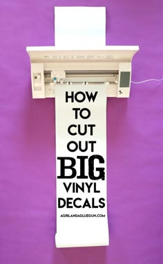 a sign hanging from the side of a purple wall that says how to cut out big vinyl decals