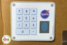 a close up of a computer keyboard with a fingerprint on the keypad and space stickers