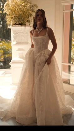 a woman in a wedding dress posing for the camera