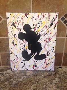 a mickey mouse painting on a tile wall