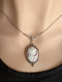 "This beautiful vintage-style Cameo necklace features a classic portrait cameo of a Greek Goddess on a wine coloured background with white relief. Set in an ornate antique silver pendant suspended from a beautiful vintage style floral necklace connector featuring vines and a Tulip. A quintessential gift for anyone that loves vintage-inspired Victorian and Gothic jewelry.  Want to make it an earring and necklace set? You can! Choose your preference in the drop-down menu! NEW! Choose your favourit Old Style Necklace, Cameo Jewelry Necklaces, Antique Jewelry Victorian Vintage Jewellery Pendant Necklace, Vintage Cameo Necklace, Vintage Looking Jewelry, Old Pendant Necklace, Victorian Necklace Aesthetic, Victorian Cameo Necklace, Victorian Style Necklace