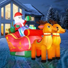 an inflatable christmas sleigh with reindeers and santa claus on it