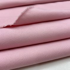 pink fabric folded on top of each other