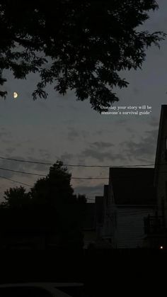 the moon is setting over some houses and trees