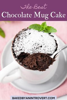 the best chocolate mug cake is in a white cup on a saucer with a spoon