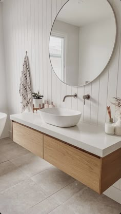 a bathroom with a sink and mirror in it