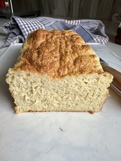 a loaf of bread sitting on top of a counter next to a knife and fork