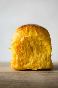 a piece of bread that has been cut in half on top of a wooden table