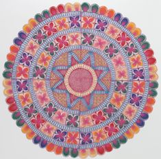 an artistically designed paper plate with flowers and circles on the front, in bright colors