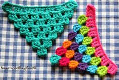 two crocheted shoes sitting on top of a blue and white checkered table cloth