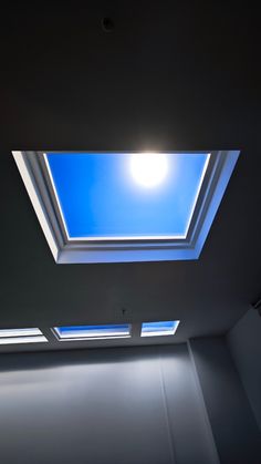 an empty room with a skylight in the ceiling