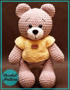 a crocheted teddy bear wearing a yellow shirt