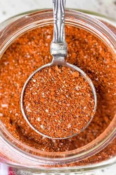 a glass jar filled with red chili seasoning