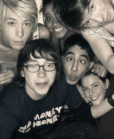 a group of young people are posing for a photo with their mouths open and eyes wide open