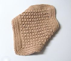 a crocheted dishcloth on a white surface