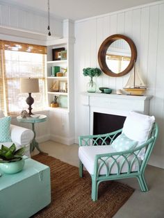 a living room filled with furniture and a fire place under a mirror on the wall